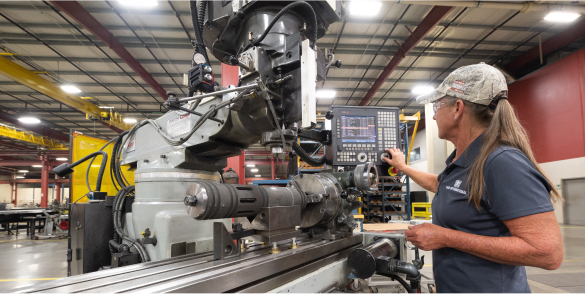 A TAM engineer preparing to run tests on equipment on a metal track 