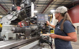 A TAM engineer preparing to run tests on equipment on a metal track 