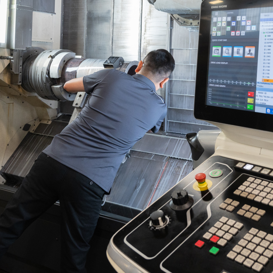 A TAM engineer looking at the inside of a packer part being tested