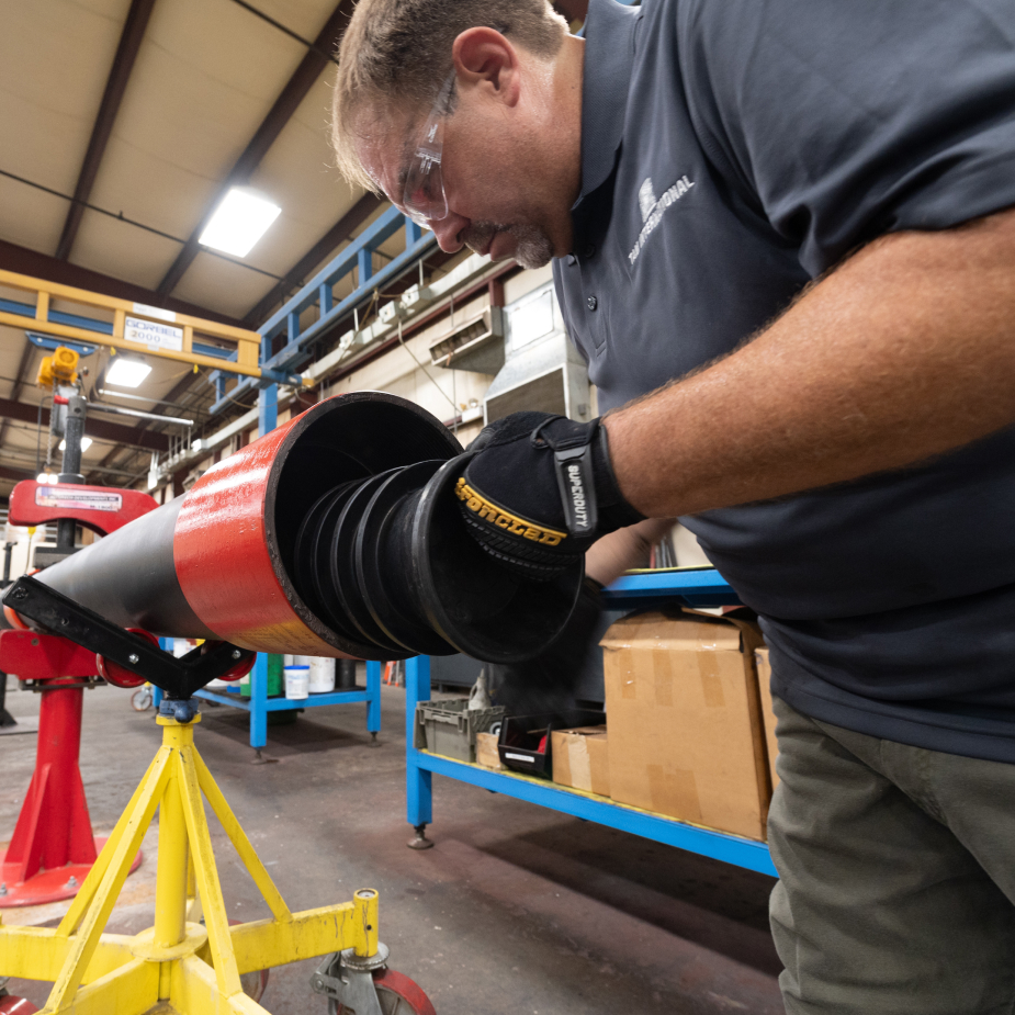 A TAM team member loading inner tubing to a packer