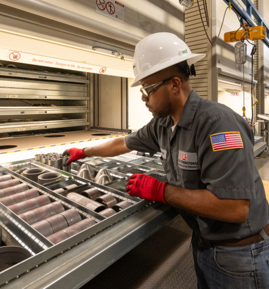 A TAM team member arranging packer parts neatly on a tray