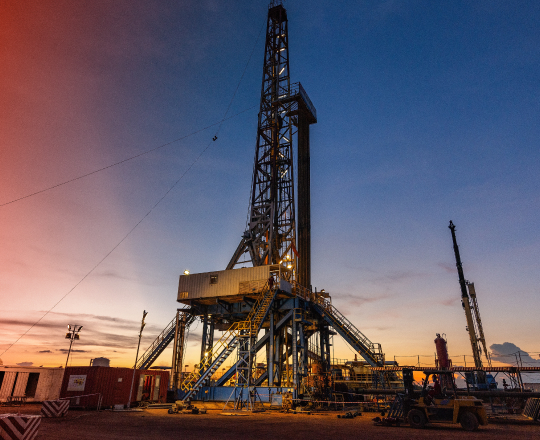 An oil derrick tower at dusk