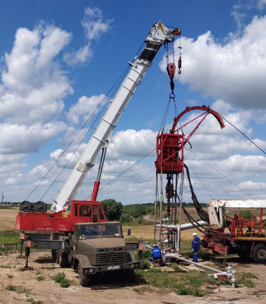 An oil derrick being built in the countryside