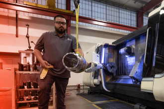 A TAM engineering using a harness to move a heavy packer part out of a machine