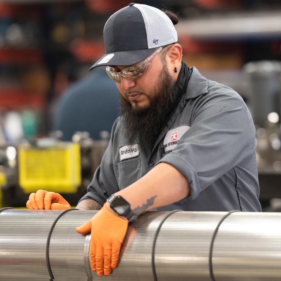 A TAM team member rolling a packer, inspecting it