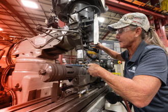 A TAM engineering drilling holes into downhole equipment using a machine