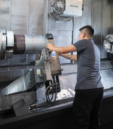 A TAM engineer adjusting heavy equipment 