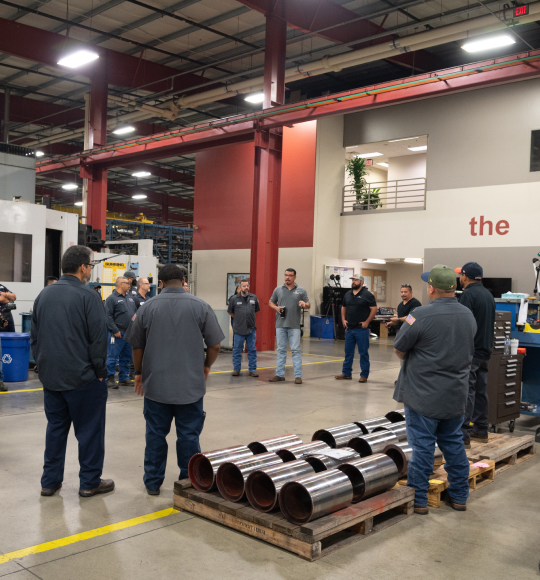 TAM facility workers gathered around in the main hall for a meeting