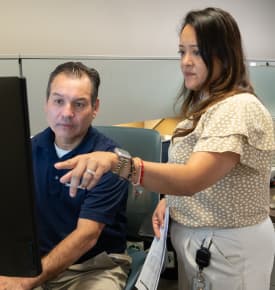 A TAM sales rep walking through downhole designs with an engineer