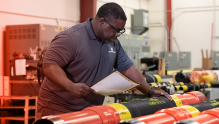 A TAM engineering going over a safety sheet while inspecting packers