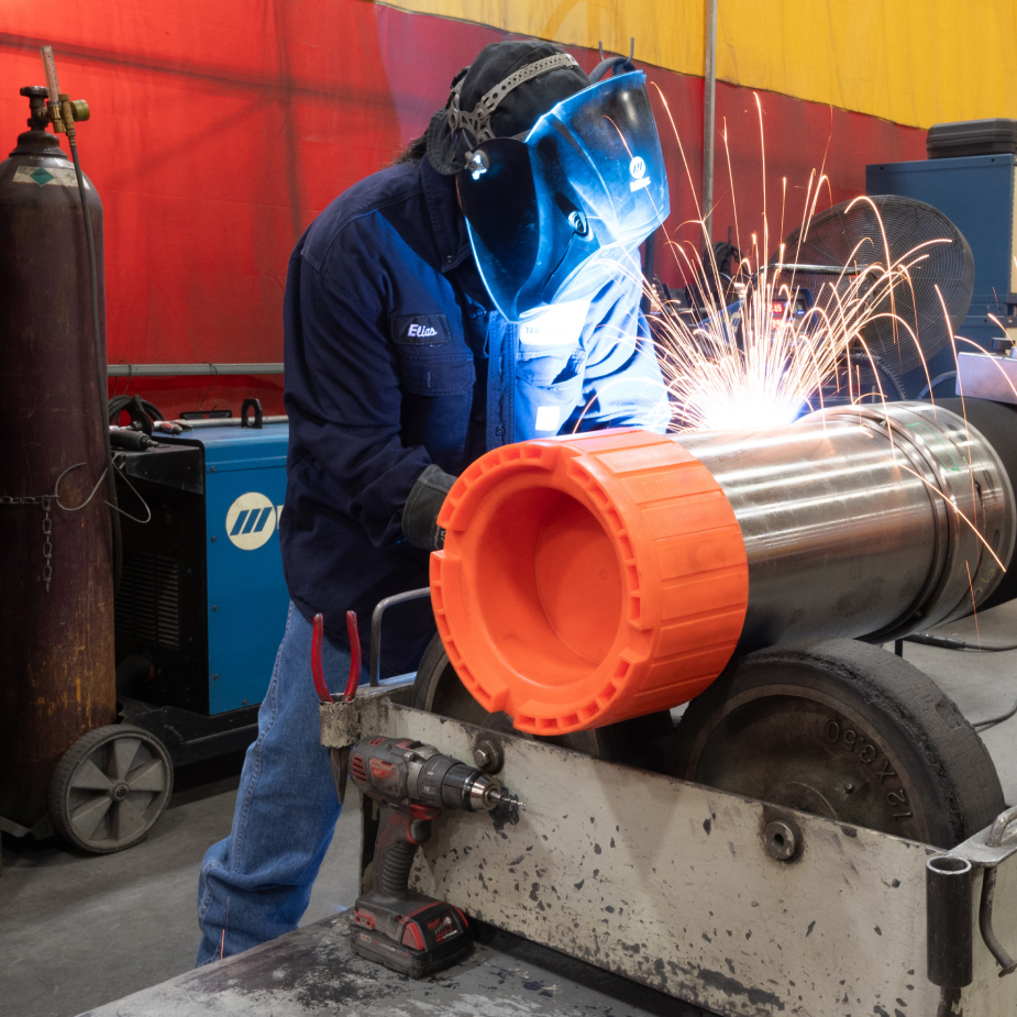 A TAM team member welding a downhole packer