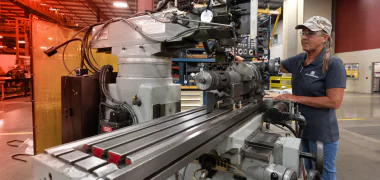 A TAM engineer loading equipment on to a metal track to test it