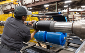 A TAM team member adjusting parts on a downhole packer