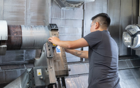 A TAM engineer adjusting heavy equipment 