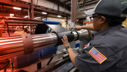 A TAM team member drilling a hole in a pipe