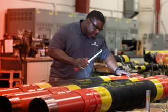 A TAM team member using a light to check packer serial numbers