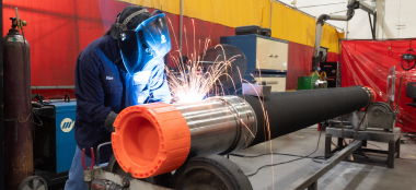 A TAM team member welding a downhole packer