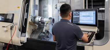 A TAM engineer entering information into a machine to test the durability of a downhole packer